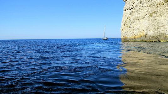 white boat near the island thumbnail