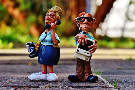tilt lens photography of two figurines standing on floor thumbnail