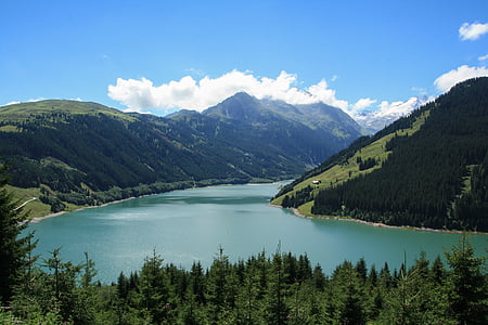 body of water near mountain under clear blue sky thumbnail