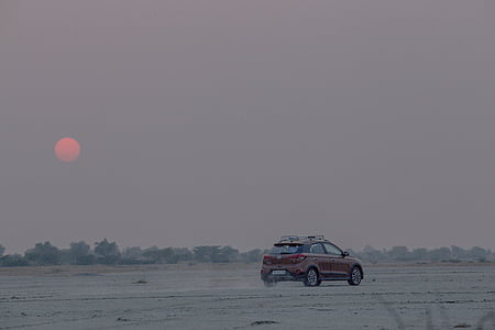 red SUV on open field thumbnail