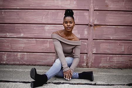 woman sitting behind purple wooden wall thumbnail