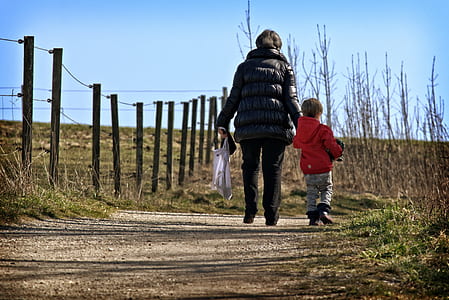 woman holding the hand of the boy thumbnail