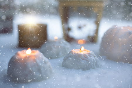 lighted tealight on snow thumbnail
