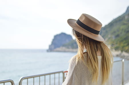 woman in white top standing on beside of beach thumbnail