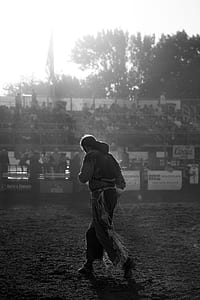 grayscale photo of man standing on stadium thumbnail