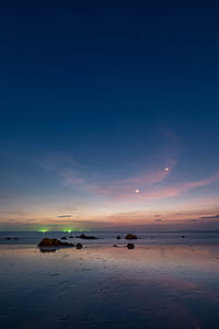 body of water under blue sky thumbnail