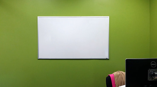 gray framed whiteboard on green wall thumbnail