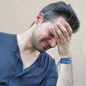 man touching his forehead thumbnail