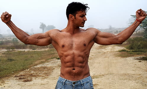 topless man wearing blue-washed denim bottoms thumbnail