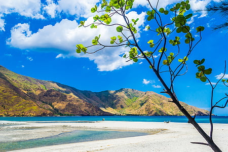 blue ocean water with mountain under blue sky and white clouds view during daytime thumbnail