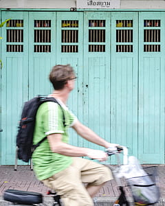 man riding black bicycle thumbnail