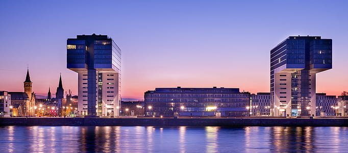 architectural photography of high-rise buildings near body of water thumbnail