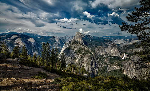 gray high mountain surrounded by tree thumbnail