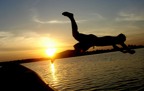 man jumping on the ocean during golden hour thumbnail