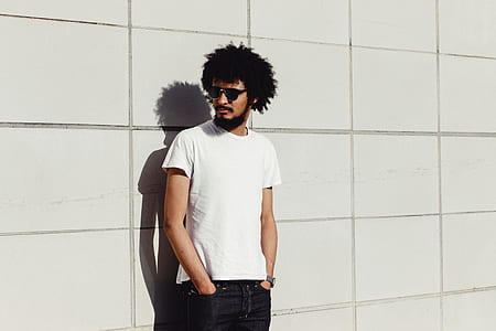 man wearing white crew-neck t-shirt and blue denim jeans thumbnail