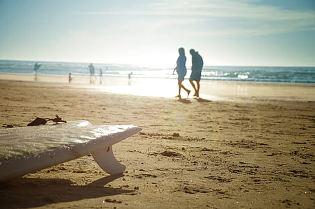 people beside brown sand during daytime thumbnail