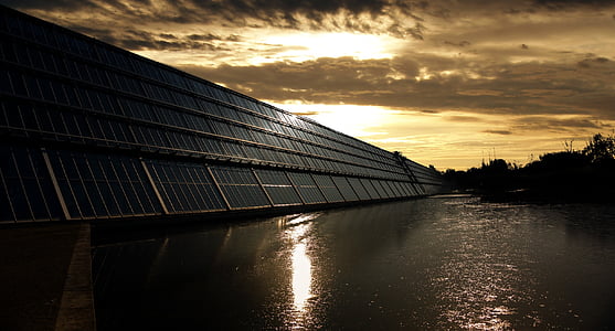 blue solar panel beside body of water during sunset in close-up photography thumbnail