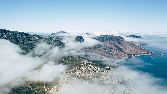 high-angle photography of mountain near body of water thumbnail