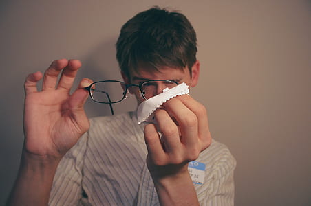 person cleaning his eyeglasses thumbnail