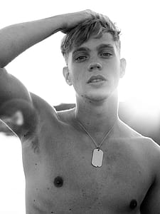 grayscale photography of man touching his hair thumbnail