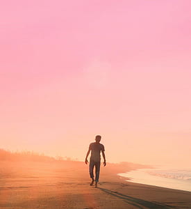 man walking beside beach thumbnail