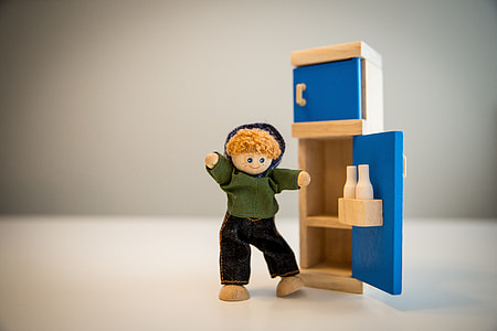 green dressed doll boy near on the blue cabinet toy thumbnail