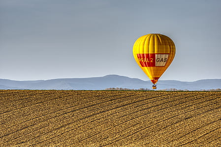yellow and red hot air balloon during daytime thumbnail
