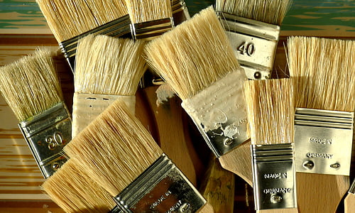 brown handle paint brush lot on top printed surface thumbnail
