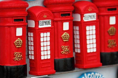 close-up photography of two red telephone booths miniatures thumbnail