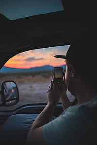 man taking photo of sunset thumbnail