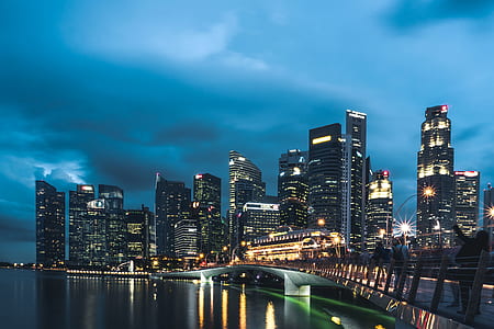 city building lights near body of water thumbnail