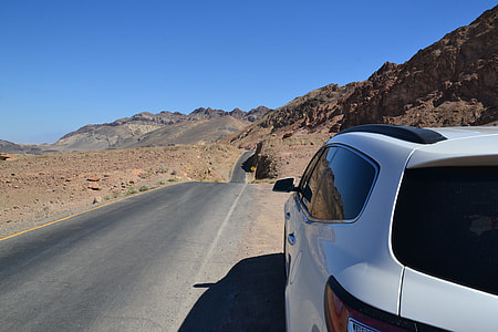 white SUV parked beside road during daytime thumbnail