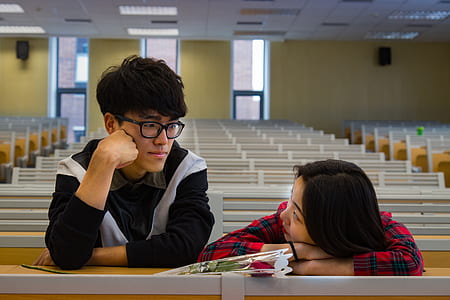 man leaning on chair beside woman watching him sinde room thumbnail