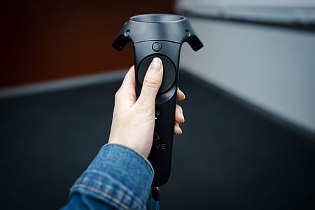 person holding black corded controller thumbnail