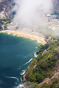 aerial photo of buildings near body of water thumbnail