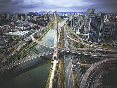 photo of suspension bridge and high-rise building thumbnail