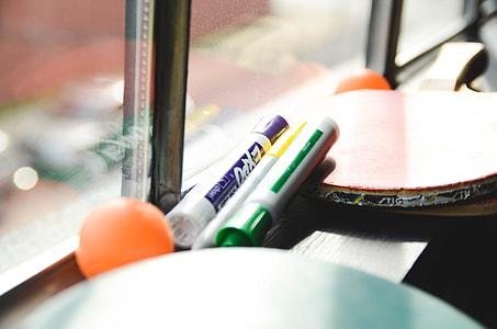 two orange table tennis ball with rackets thumbnail