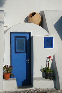 closed blue door of white building thumbnail