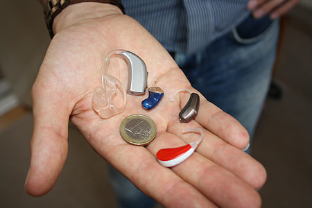 four hearing aids in person's palm thumbnail