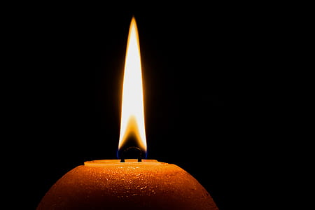 lighted candle during nighttime thumbnail