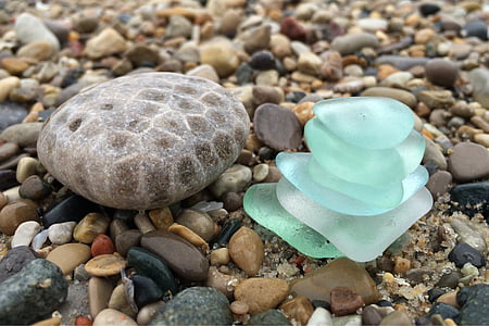 stacks of green stones beside round gray rock thumbnail