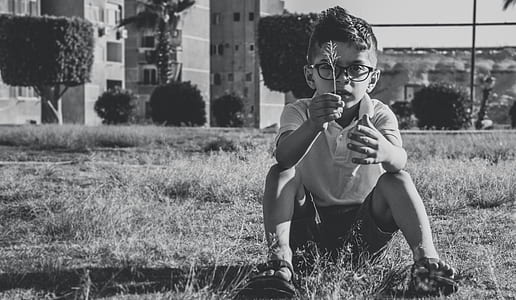 Greyscale Photo Of Boy Wearing Eyeglasses thumbnail