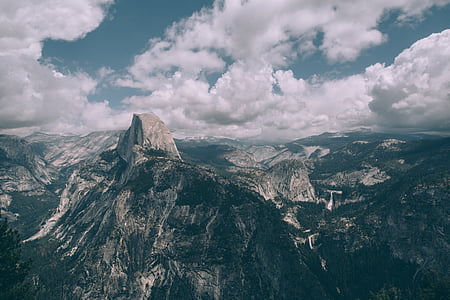 bird's eye view photography of mountains under white clouds thumbnail
