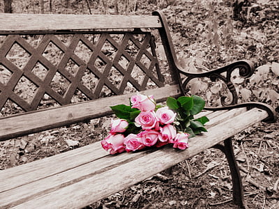 red rose arrangement on brown wooden bench thumbnail