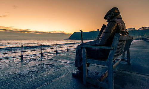 man sitting on bench statue thumbnail