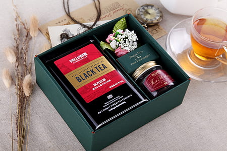 green box beside clear glass tea cup thumbnail