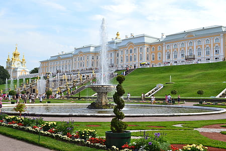 water fountain near people standing on park during daytime thumbnail