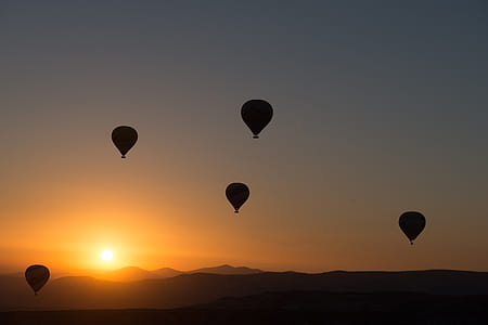 silhouette of five hot air balloons during sunset thumbnail