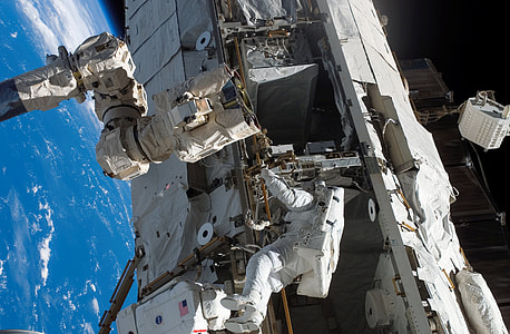 astronaut floating outside space station thumbnail