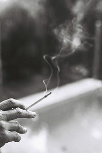 person holding cigarette stick thumbnail